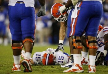 LEXINGTON, KY - SEPTEMBER 26: Quarterback Tim Tebow #15 of the Florida Gators lays on the ground after being sacked by Taylor Wyndham #94 of the Kentucky Wildcats during the third quarter of the game at Commonwealth Stadium on September 26, 2009 in Lexing