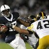 STATE COLLEGE, PA - SEPTEMBER 26:  Daryll Clark #17 of the Penn State Nittnay Lions is tackled by Karl Klug #95 and Jeremiha Hunter #42 of the Iowa Hawkeye's on September 26, 2009 at Beaver Stadium in State College, Pennsylvania.  (Photo by Gregory Shamus