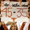AUSTIN, TX - NOVEMBER 27:  A Texas Longhorn fan cheers on her team against the Texas A&M Aggies while holding a reminder of the Texas score against Oklahoma earlier in the season at Darrell K Royal-Texas Memorial Stadium November 27, 2008 in Austin, Texas