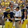 ANN ARBOR, MI - SEPTEMBER 19: Head coach Rich Rodriguez of the Michigan Wolverines is flanked by quarterbacks Tate Forcier #5 and David Cone #17 as he signals during the game with the Eastern Michigan Eagles at Michigan Stadium on September 19, 2009 in An