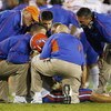 LEXINGTON, KY - SEPTEMBER 26: Quarterback Tim Tebow #15 of the Florida Gators is tended to by head coach Urban Meyer (R) and staff after Tebow was sacked by Taylor Wyndham #94 of the Kentucky Wildcats during the third quarter of the game at Commonwealth S