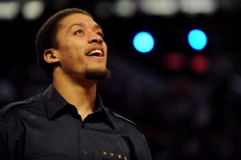 PHOENIX - FEBRUARY 14:  Michael Beasley of the Miami Heat watches teammate Daequan Cook of the Heat participate in the Foot Locker Three-Point Shootout on All-Star Saturday Night, part of 2009 NBA All-Star Weekend at US Airways Center on February 14, 2009