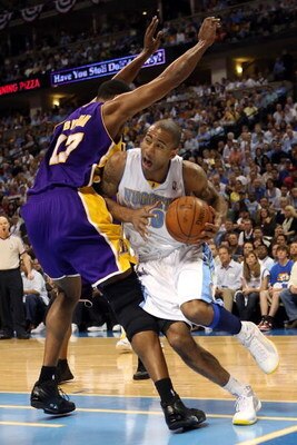 DENVER - MAY 29:  Dahntay Jones #30 of the Denver Nuggets drives on Andrew Bynum #17 of the Los Angeles Lakers in the first quarter of Game Six of the Western Conference Finals during the 2009 NBA Playoffs at Pepsi Center on May 29, 2009 in Denver, Colora