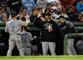 BOSTON - SEPTEMBER 29:  Aaron Hill #2 and Adam Lind #26 of the Toronto Blue Jays are congratulated by teammates after Lind hit a two run homer in the first inning against the Boston Red Sox on September 29, 2009 at Fenway Park in Boston, Massachusetts.  (