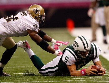 NEW ORLEANS - OCTOBER 04:  Quarterback Mark Sanchez #6 of the New York Jets dives for a first down around Roman Harper #41 of the New Orleans Saints at the Louisana Superdome on October 4, 2009 in New Orleans, Louisiana.  (Photo by Chris Graythen/Getty Im