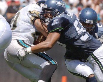 Seattle Seahawks linebacker Jamie Sharper stops  Jacksonville Jaguars running back Fred Taylor  at Alltel Stadium, September 11, 2005 in Jacksonville.  (Photo by Al Messerschmidt/Getty Images)