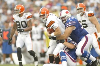 ORCHARD PARK, NY - AUGUST 26:  Quaterback Charlie Frye #9 of the Cleveland Browns is tackled by defensive tackle Tim Anderson #77 of the Buffalo Bills during the preseason game on August 26, 2006 at Ralph Wilson Stadium in Orchard Park, New York. The Brow