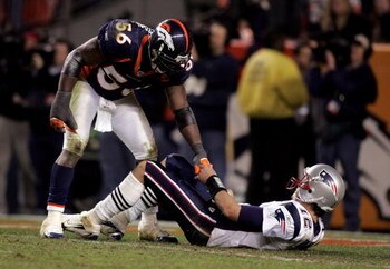 DENVER - JANUARY 14:  Linebacker Al Wilson #56 of the Denver Broncos helps quarterback Tom Brady #12 of the New England Patriots up as Brady lays on his back during the fourth quarter of the AFC Divisional Playoff game on January 14, 2006 at Invesco Field