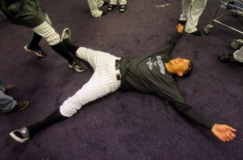 DENVER - OCTOBER 01:  Carlos Gonzalez of the Colorado Rockies lays on the floor as the Rockies celebrate in the clubhouse after they defeated the Milwaukee Brewers 9-2 and clinched a National League playoff berth at Coors Field on October 1, 2009 in Denve