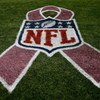 DENVER - OCTOBER 04:  The NFL logo is adorned with a pink ribbon on the sidelines as part of a program to raise awareness for breast cancer as the Dallas Cowboys face the Denver Broncos during NFL action at Invesco Field at Mile High on October 4, 2009 in