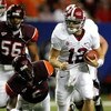 ATLANTA - SEPTEMBER 05:  Quarterback Greg McElroy #12 of the Alabama Crimson Tide rushes away from Jason Worilds #6 of the Virginia Tech Hokies during the Chick-fil-A Kickoff Game at Georgia Dome on September 5, 2009 in Atlanta, Georgia.  (Photo by Kevin 