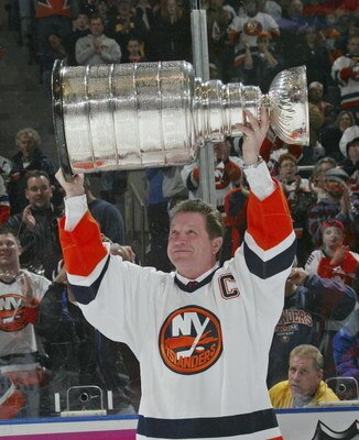 UNIONDALE, NY - MARCH 4:  Denis Potvin #5, formerly of the New York Islanders, holds up the Stanley Cup during a ceremony honoring the 25th anniversary of the Islanders first Stanley Cup victory held on March 4, 2006 at the Nassau Coliseum in Uniondale, N