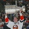 UNIONDALE, NY - MARCH 4:  Denis Potvin #5, formerly of the New York Islanders, holds up the Stanley Cup during a ceremony honoring the 25th anniversary of the Islanders first Stanley Cup victory held on March 4, 2006 at the Nassau Coliseum in Uniondale, N