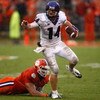 CLEMSON, SC - SEPTEMBER 26:  Andy Dalton #14 of the TCU Horned Frogs runs with the ball as Miguel Chavis #89 of the Clemson Tigers tries to tackle him during their game at Memorial Stadium on September 26, 2009 in Clemson, South Carolina.  (Photo by Stree
