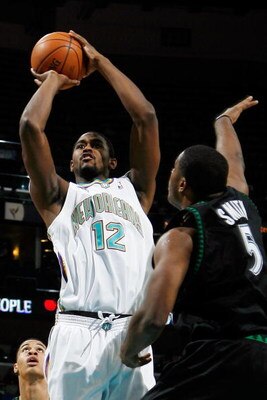NEW ORLEANS - DECEMBER 22:  Hilton Armstrong #12 of the New Orleans Hornets makes a shot over Craig Smith #5 of the Minnesota Timberwolves on December 22, 2007 at the New Orleans Arena in New Orleans, Louisiana.  NOTE TO USER: User expressly acknowledges 
