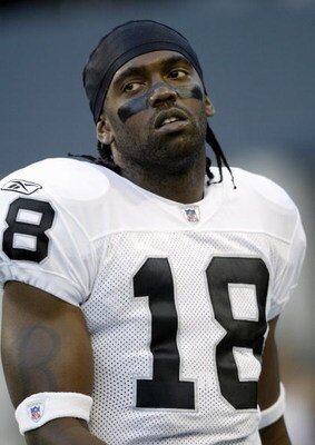 SEATTLE - AUGUST 31:  Randy Moss #18 of the Oakland Raiders rests on the sideline during the game with the Seattle Seahawks on August 31, 2006 at Qwest Field in Seattle Washington. The Seahawks won 30-7. (Photo by Otto Greule Jr/Getty Images) 