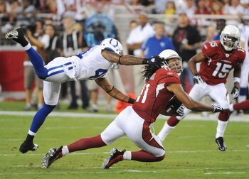 GLENDALE, AZ - SEPTEMBER 27:  Larry Fitzgerald #11 of the Arizona Cardinals makes a 16-yard catch as Antoine Bethea #41 of the Indianapolis Colts grabs his facemask for a 15-yard penalty in the second quarter during the game at University of Phoenix Stadi