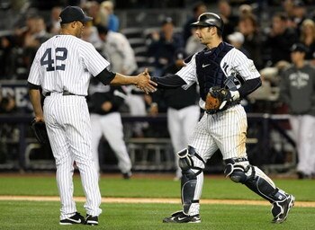 NEW YORK - OCTOBER 07:  Mariano Rivera #42 and Jorge Posada #20 of the New York Yankees celebrate after defeating the Minnesota Twins to win Game One of the ALDS during the 2009 MLB Playoffs at Yankee Stadium on October 7, 2009 in the Bronx borough of New
