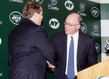 UNIONDALE, NY - JANUARY 17: Chairman and CEO of the New York Jets Woody Johnson (R) congradulates Eric Mangini during the press conference introducing Mangini as the new head coach of the Jets on January 17, 2006 at the Jets Complex at Hofsta University i