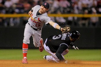 DENVER - SEPTEMBER 26:  Eric Young Jr. #3 of the Colorado Rockies steals second base as shortstop Brendan Ryan #13 of the St. Louis Cardinals takes the throw at Coors Field on September 26, 2009 in Denver, Colorado. The Cardinals clinched the National Lea