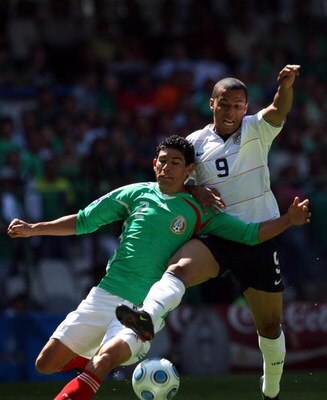MEXICO CITY - AUGUST 12:  Jonny Magallon #2 of Mexico and Charlie Davies #9 of the USA clash for the ball during the FIFA World Cup Qualifying soccer match between the USA and Mexico at Azteco Stadium August 12, 2009 in Mexico City, Mexico.  (Donald Miral