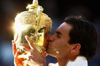 WIMBLEDON, ENGLAND - JULY 05:  Roger Federer of Switzerland kisses the trophy after victory during the men's singles final match against Andy Roddick of USA on Day Thirteen of the Wimbledon Lawn Tennis Championships at the All England Lawn Tennis and Croq