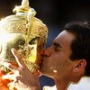 WIMBLEDON, ENGLAND - JULY 05:  Roger Federer of Switzerland kisses the trophy after victory during the men's singles final match against Andy Roddick of USA on Day Thirteen of the Wimbledon Lawn Tennis Championships at the All England Lawn Tennis and Croq