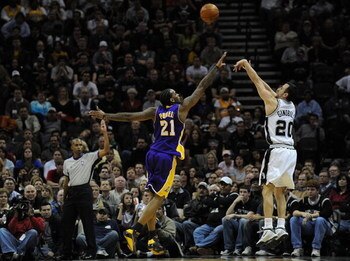 SAN ANTONIO - JANUARY 14: Manu Ginobili #20 of the San Antonio Spurs takes a shot against Josh Powell #21 of the Los Angeles Lakers on January 14, 2009 at AT&T Center in San Antonio, Texas. NOTE TO USER: User expressly acknowledges and agrees that, by d