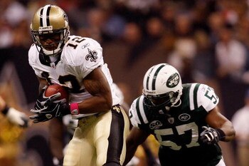 NEW ORLEANS - OCTOBER 04:  Marques Colston #12 of the New Orleans Saints makes a catch over Bart Scott #57 of the New York Jets at the Louisana Superdome on October 4, 2009 in New Orleans, Louisiana.  (Photo by Chris Graythen/Getty Images)