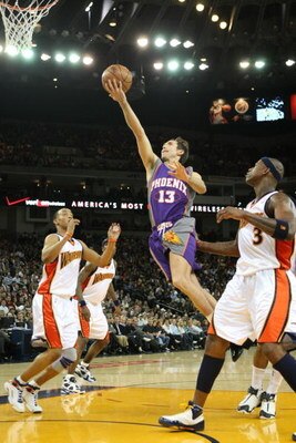 OAKLAND, CA - FEBRUARY 13: Steve Nash #13 of the Phoenix Suns shoots over Monta Ellis 38 and Al Harrington #3 of the Golden State Warriors during an NBA game on February 13, 2008 at Oracle Arena in Oakland, California. NOTE TO USER: User expressly acknowl