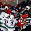 CHICAGO - MAY 05:  Officials attempt to seperate players from the Chicago Blackhawks and the Vancouver Canucks as they fight along the boards during the first period of Game Three of the Western Conference Semifinal Round of the 2009 Stanley Cup Playoffs 