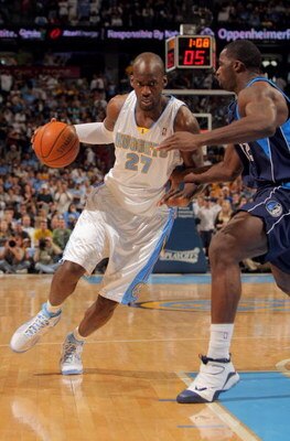DENVER - MAY 03:  Johan Petro #27 of the Denver Nuggets drives against the defense of Brandon Bass #32 of the Dallas Mavericks in Game One of the Western Conference Semifinals during the 2009 NBA Playoffs at Pepsi Center on May 3, 2009 in Denver, Colorado