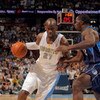 DENVER - MAY 03:  Johan Petro #27 of the Denver Nuggets drives against the defense of Brandon Bass #32 of the Dallas Mavericks in Game One of the Western Conference Semifinals during the 2009 NBA Playoffs at Pepsi Center on May 3, 2009 in Denver, Colorado