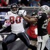 HOUSTON - OCTOBER 04:  Wide receiver Andre Johnson #80 of the Houston Texans gives safety Michael Huff #24 of the Oakland Raiders a stiff arm after making a 62 yard reception at Reliant Stadium on October 4, 2009 in Houston, Texas.  (Photo by Bob Levey/Ge