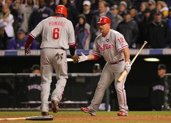 DENVER - OCTOBER 12:  Matt Stairs #12 of the Philadelphia Phillies congratulates teammate Ryan Howard #6 after Howard scored the go ahead run against the Colorado Rockies in the top of the ninth inning giving the Phillies a 5-4 lead in Game Four of the NL