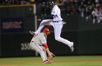 DENVER - OCTOBER 12:  Dexter Fowler #24 of the Colorado Rockies hurdles safely over Chase Utley #26 the Philadelphia Phillies in Game Four of the NLDS during the 2009 MLB Playoffs at Coors Field on October 12, 2009 in Denver, Colorado.  (Photo by Doug Pen
