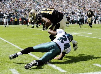PHILADELPHIA - SEPTEMBER 20: Sheldon Brown #24 of the Philadelphia Eagles takes down Marques Colston #12 of the New Orleans Saints during their game at Lincoln Financial Field on September 20, 2009 in Philadelphia, Pennsylvania.  (Photo by Jeff Zelevansky