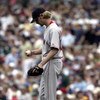 CHICAGO - JUNE 10:  Starting pitcher Bronson Arroyo #61 of the Boston Red Sox reacts after giving up runs in the third inning to the Chicago Cubs on June 10, 2005 at Wrigley Field in Chicago, Illinois. The Cubs defeated the Red Sox 14-6.  (Photo by Jonath