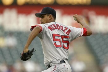 ARLINGTON, TEXAS - JULY 30:  Pitcher Ramiro Mendoza #55 of the Boston Red Sox delivers a pitch during the American League game against the Texas Rangers at the Ballpark in Arlington on July 30, 2003 in Arlington, Texas.  The Rangers defeated the Red Sox 9