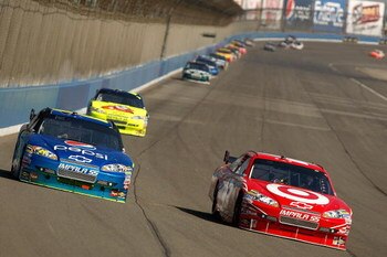 FONTANA, CA - OCTOBER 11:  Juan Pablo Montoya, driver of the #42 Target Chevrolet, races Jeff Gordon, driver of the #24 Pepsi Chevrolet, during the NASCAR Sprint Cup Series Pepsi 500 at Auto Club Speedway on October 11, 2009 in Fontana, California.  (Phot