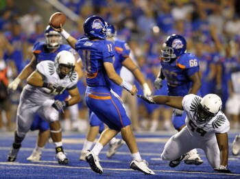 BOISE, ID - SEPTEMBER 3: Quarterback Kellen Moore #11 of the Boise State Broncos gets off a pass under the rush of Zac Clark #99 and Terrance Montgomery #59 of the Oregon Ducks in the fourth quarter of the game on September 3, 2009 at Bronco Stadium in Bo