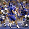 BOISE, ID - SEPTEMBER 3: Quarterback Kellen Moore #11 of the Boise State Broncos gets off a pass under the rush of Zac Clark #99 and Terrance Montgomery #59 of the Oregon Ducks in the fourth quarter of the game on September 3, 2009 at Bronco Stadium in Bo