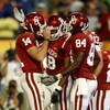 MIAMI - JANUARY 08:  Sam Bradford #14 of the Oklahoma Sooners celebrates with teammates Jermaine Gresham #18 and Quentin Chaney #84 after scoring a touchdown againist the Florida Gators during the FedEx BCS National Championship Game at Dolphin Stadium on