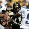 PITTSBURGH - SEPTEMBER 11: Aaron Smith #91 of the Pittsburgh Steelers rushes quarterback Steve McNair #9 of the Tennessee Titans as tackle Jacob Bell #60 attempts to block on September 11, 2005 at Heinz Field in Pittsburgh, Pennsylvania. The Steelers defe
