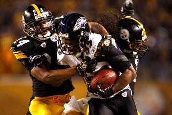 PITTSBURGH - JANUARY 18:  Ike Taylor #24 and Troy Polamalu #43 of the Pittsburgh Steelers tackle Derrick Mason #85 of the Baltimore Ravens during the AFC Championship game on January 18, 2009 at Heinz Field in Pittsburgh, Pennsylvania.  (Photo by Streeter