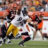 CINCINNATI - SEPTEMBER 27:  Carson Palmer #9 of the Cincinnati Bengals runs with the ball while defended by James Harrison #92 of the Pittsburgh Steelers at Paul Brown Stadium on September 27, 2009 in Cincinnati, Ohio.  The Bengals won 23-20.  (Photo by A