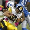 DETROIT , MI - OCTOBER 11:  Hines Ward #86 of the Pittsburgh Steelers is tackled after a fourth quarter catch by Louis Delmas #26 of the Detroit Lions on October 11, 2009 at Ford Field in Detroit, Michigan. Pittsburgh won the game 28-20.(Photo by Gregory 