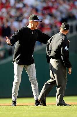 PHILADELPHIA - OCTOBER 07:  Manager Jim Tracy (L) of the Colorado Rockies argues with second base umpire Jerry Meals after he felt Cliff Lee #34 of the Philadelphia Phillies should of been called out on a pickoff attempt at second base in the bottom of th