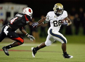 LOUISVILLE, KY - OCTOBER 02:  Dion Lewis #28 of the Pittsburgh Panthers runs with the ball  while defended by Chaz Thompson #4 of the Louisville Cardinals during the Big East Conference game at Papa John's Cardinal Stadium on October 2, 2009 in Louisville