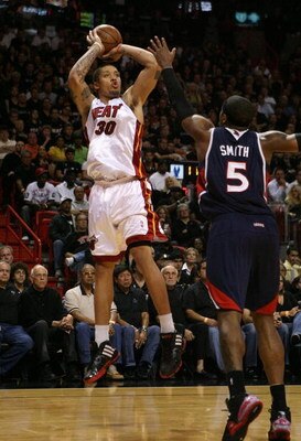 MIAMI - APRIL 27:  Michael Beasley #30 of the Miami Heat shoots over Josh Smith #5 of the Atlanta Hawks during Game Four of the Eastern Conference Quarterfinals of the 2009 NBA Playoffs at American Airlines Arena on April 27, 2009 in Miami, Florida. NOTE 